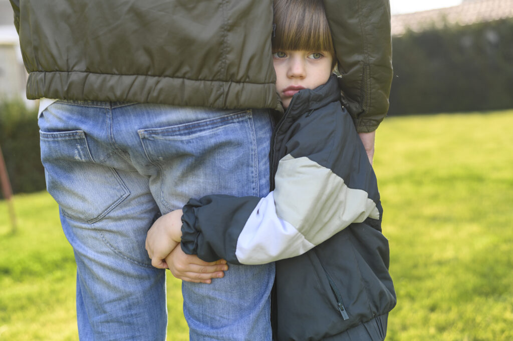 close-up-kid-holding-adult-s-leg